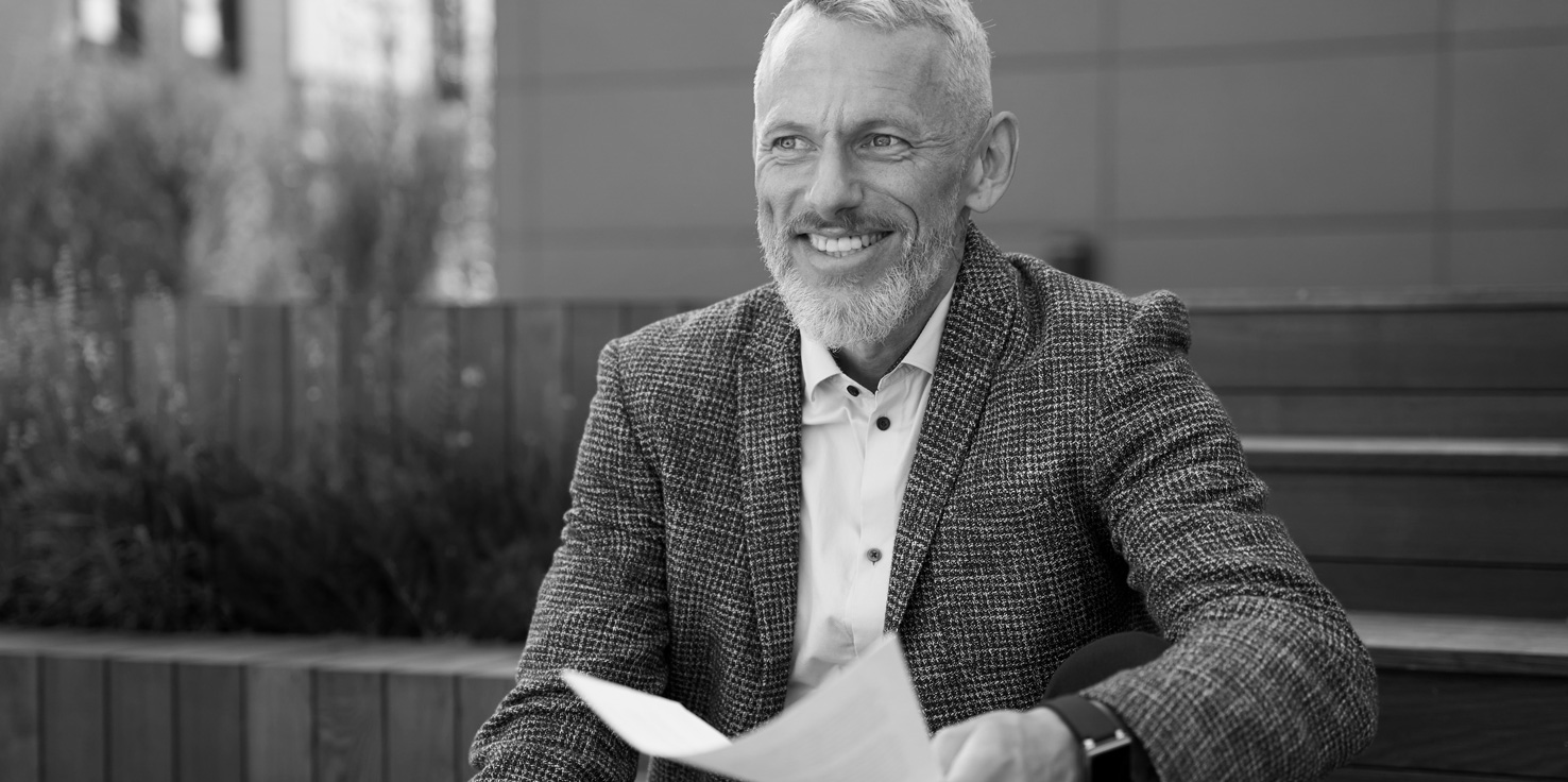 Cheerful man reviewing his wealth creation plan