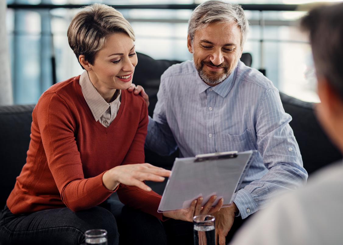 Couple reviewing their finances with an advisor