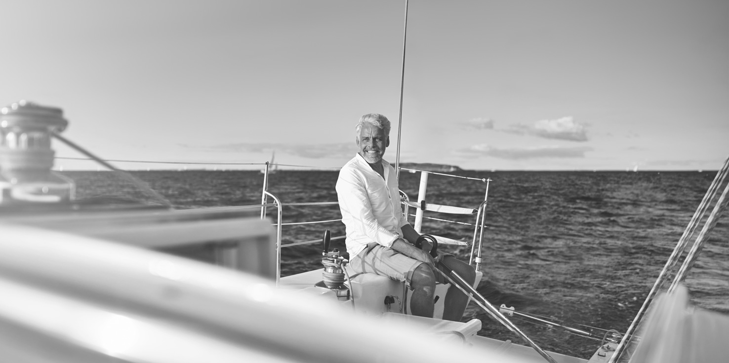 Mature man enjoying his retirement on a sailboat